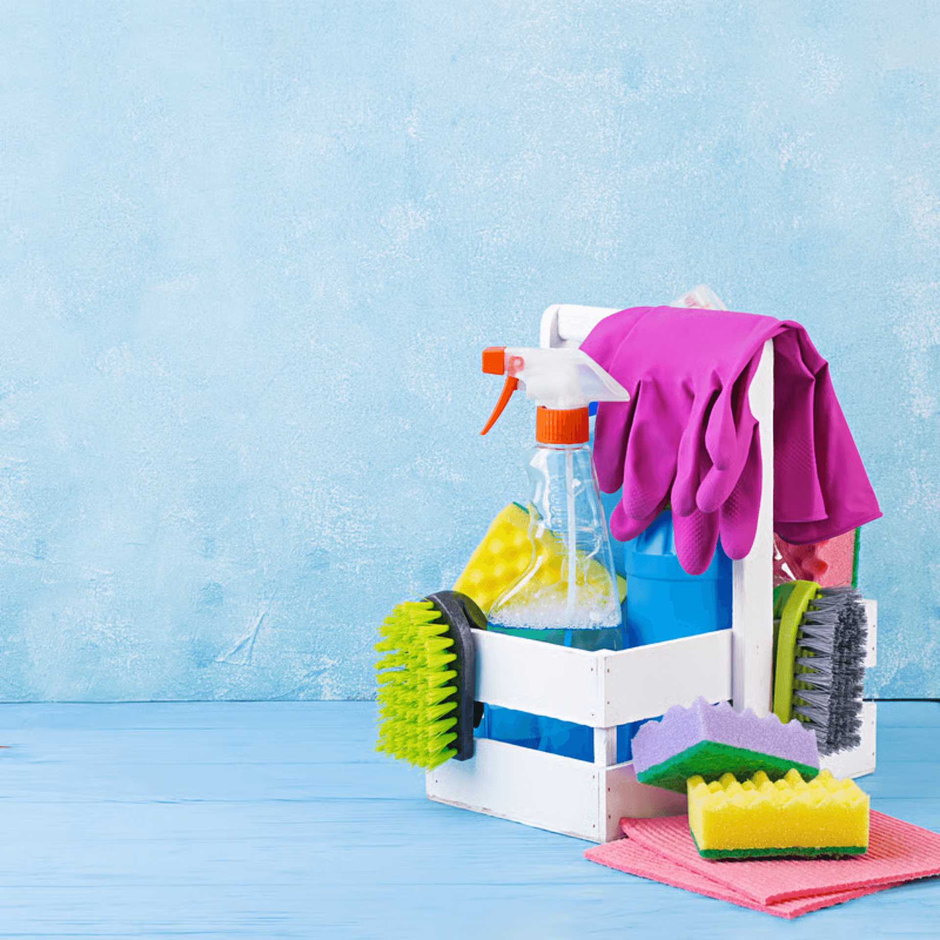 A cleaning supplies kit with cloths and bottles ready for a home cleaning visit